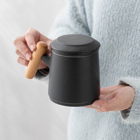 Ceramic cup with wooden handle