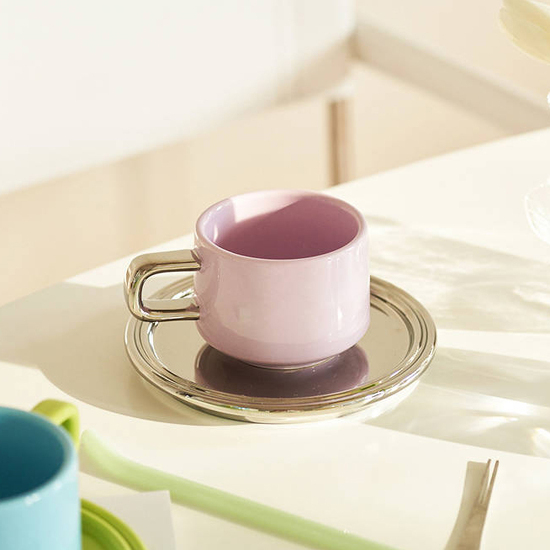 Contrast color coffee cup with saucer